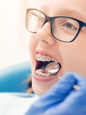 There is nothing to be afraid of. Scaled up shot of a child patient with braces opening her mouth while sitting on a chair and waiting for a dental professional to examine her teeth